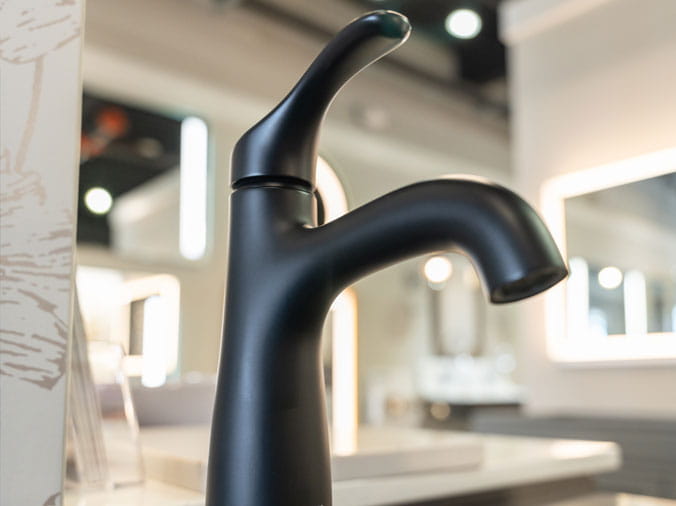Closeup of a black bathroom faucet